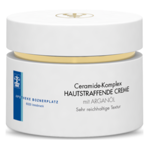 Weißer Cremebehälter mit goldener Verschlusskappe und Aufschrift über den Ceramide-Komplex und Arganöl.