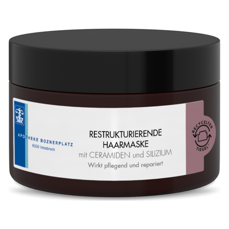 Dunkelbrauner Tiegel mit schwarzem Deckel, Beschriftung zu restrukturierender Haarmaske mit Ceramiden und Silizium.