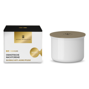 Packung mit ocre Farbverlauf, schwarzem Deckel, daneben schlichte weiße Nachcreme mit Holzdeckel und Logo.