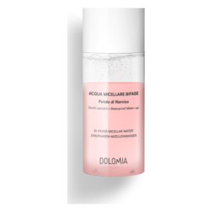 Zweiphasen-Mizellenwasser in einem transparenten Behälter mit pinker Flüssigkeit und einem weißen Deckel.