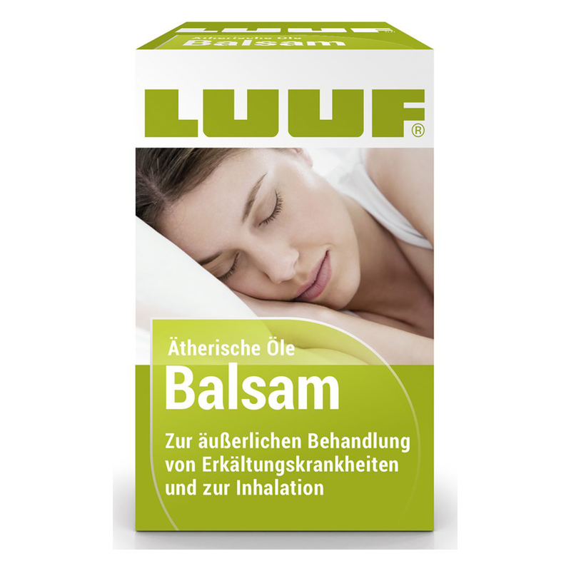 Verpackung des LUUF Balsams mit Aufschrift zu ätherischen Ölen und Anwendung bei Erkältungen, abgebildet auf einem Kissen.