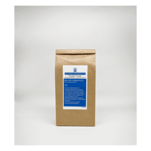 Papiertüte mit Baldrianwurzel, versehen mit blauer Beschriftung und Warnhinweisen zur Anwendung.