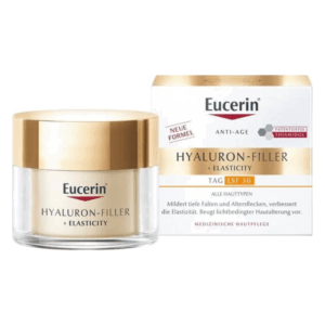 Eucerin Hyaluron-Filler + Elasticity Tagescreme in glasartigem Behälter mit goldfarbenem Deckel, umgeben von der Verpackung.