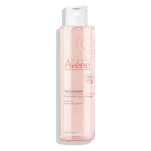 Transparentes Behältnis mit Gesichts-Gel von Avène, geeignet für empfindliche Haut, rosafarbene Flüssigkeit.